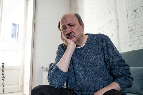 Depressed overwhelmed old man feeling exhausted alone and unhappy suffering from depression