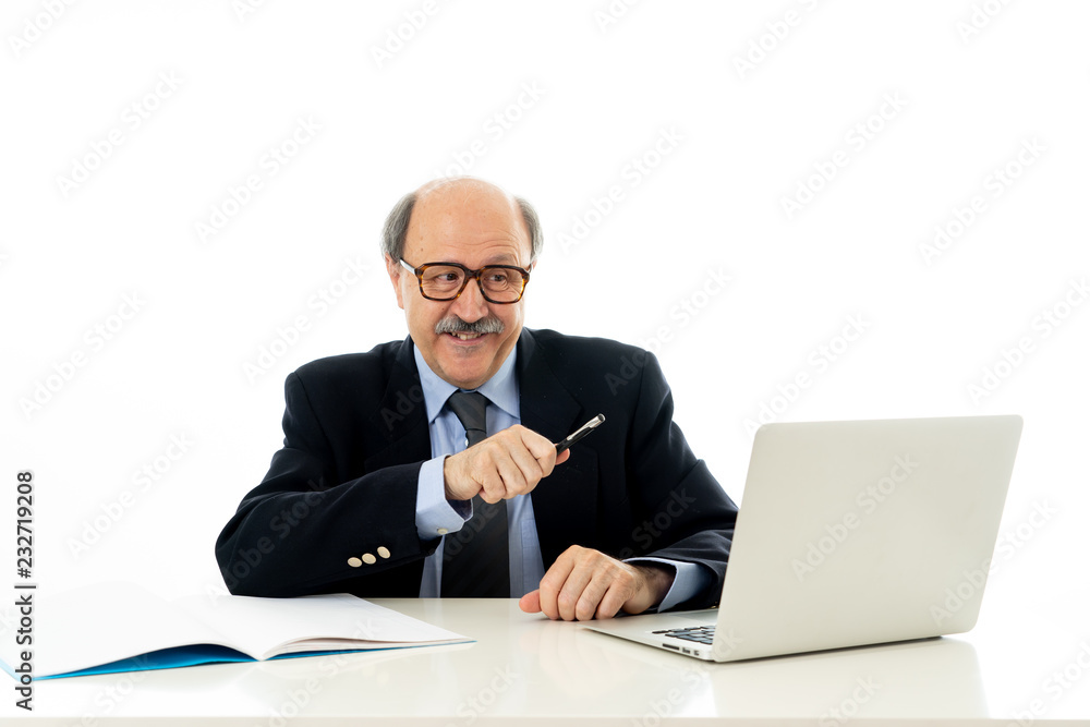 Pleased mature business man in his 60s working on laptop confident of success Pleased mature business man in his 60s working on laptop confident of success