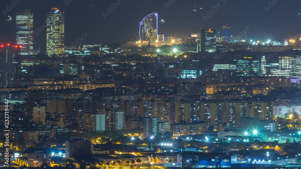 Barcelona and Badalona skyline with roofs of houses and sea on the horizon night timelapse Barcelona and Badalona skyline with roofs of houses and sea on the horizon night timelapse
