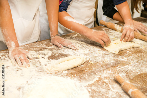 Young children make dough products. Hands closeup © Rakursstudio
