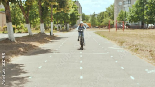 Wallpaper Mural An eleven-year-old girl in a good mood rides a bicycle and after a stop shows a thumbs-up. Torontodigital.ca