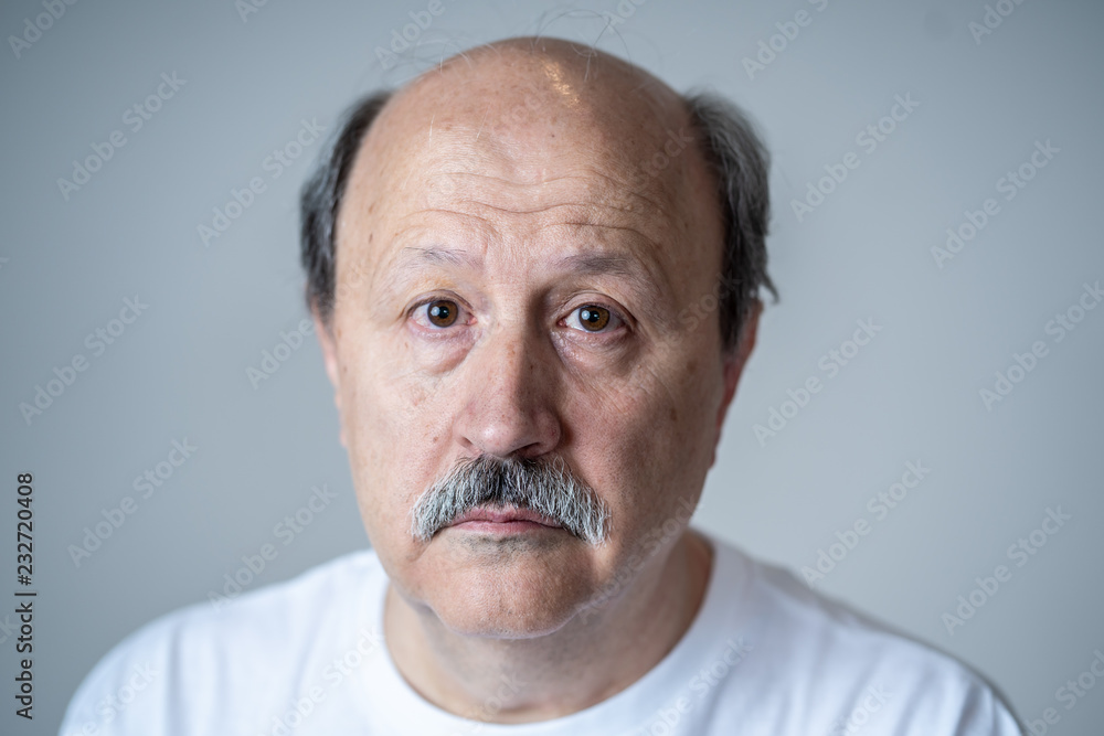 Close up portrait of sad old man face suffering from depression Close up portrait of sad old man face suffering from depression