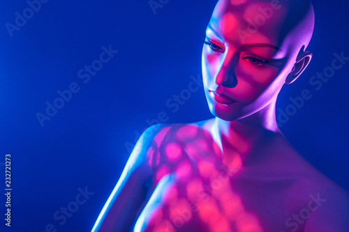 Mannequin in red light. Female robot Artificial Intelligence. Portrait of a woman. Mannequin in pink color.