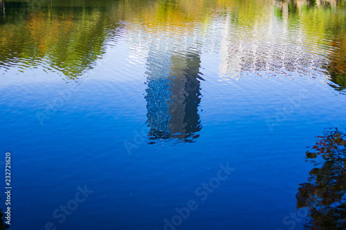 Reflection of buildings and maple trees on a pond in Japanese garden (Koishikawa Korakuen, Tokyo, Japan) photo