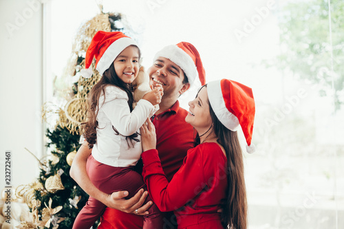 Young family celebrating Christmas at home.Happy young family enjoying their holiday time together.