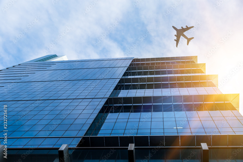 Airplane above business city Airplane above business city