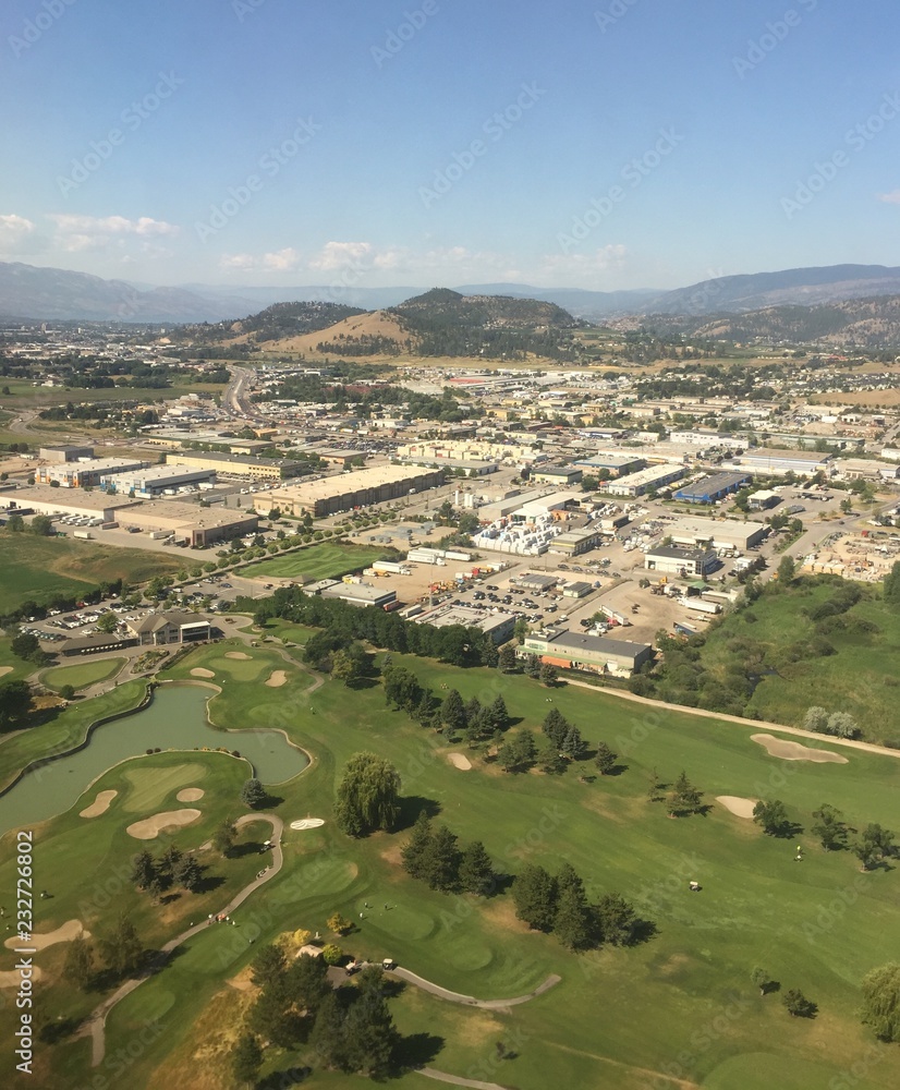 Aerial view over Kelowna BC with golfers in foreground