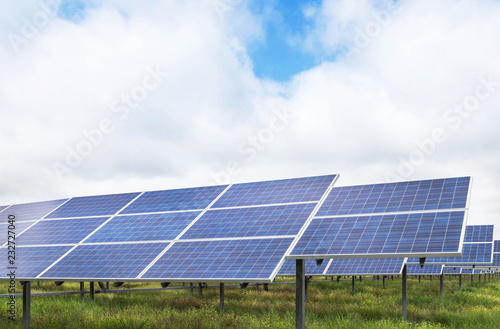 Close up rows array of polycrystalline silicon solar cells or photovoltaics in solar power plant turn up skyward absorb the sunlight from the sun alternative renewable energy on blue sky 