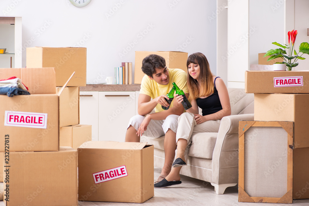 Young couple moving to new flat with fragile things Young couple moving to new flat with fragile things