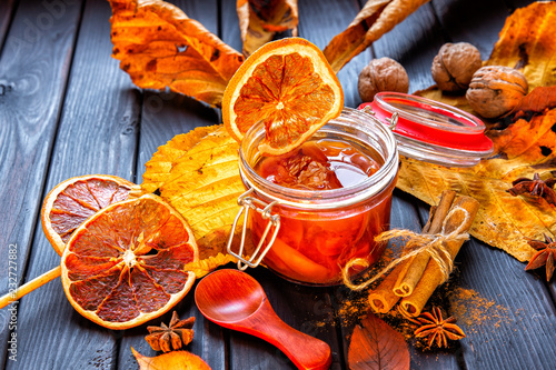 Apple-pumpkin jam with orange decorated with autumn leaves.Autumn season