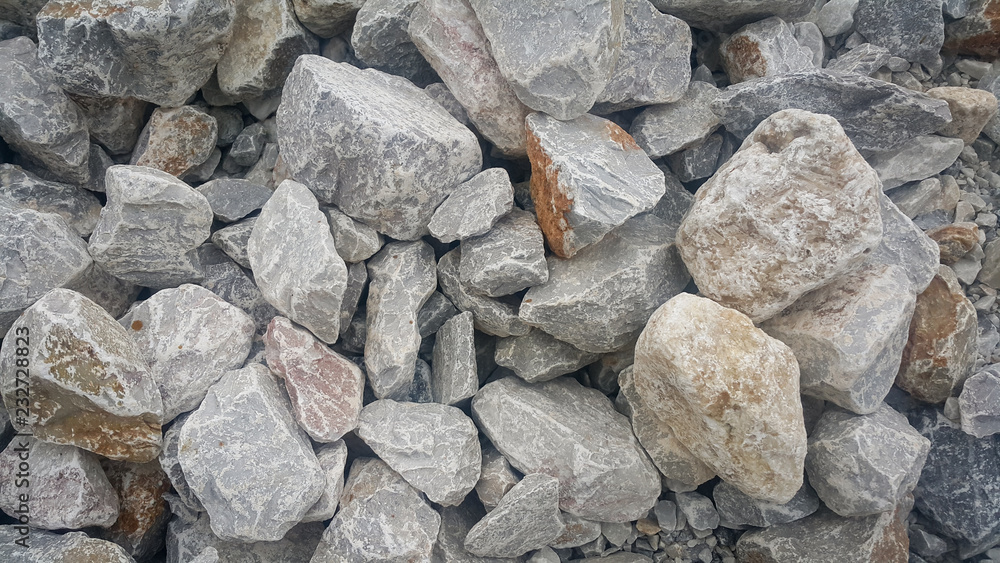 Large and small piles of limestone for use in lime kiln line  . Limestone gravel background Texture.