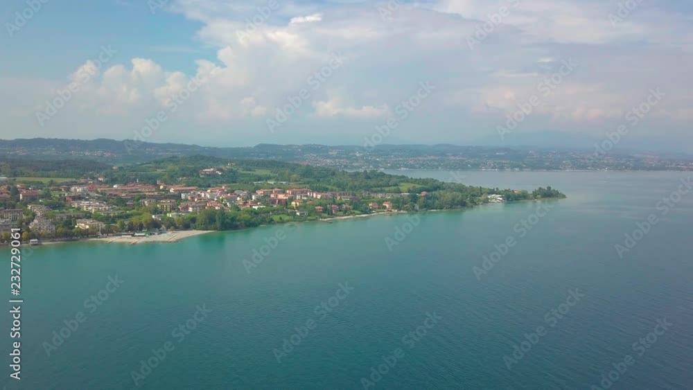 Aerial view of boats and coast of Lake Garda, Italy. Flying over boats and shoreline of Lago di Garda on summer holiday. Aerial view of boats and coast of Lake Garda, Italy. Flying over boats and shoreline of Lago di Garda on summer holiday.