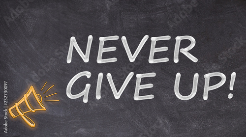 Never give up written on blackboard with megaphone