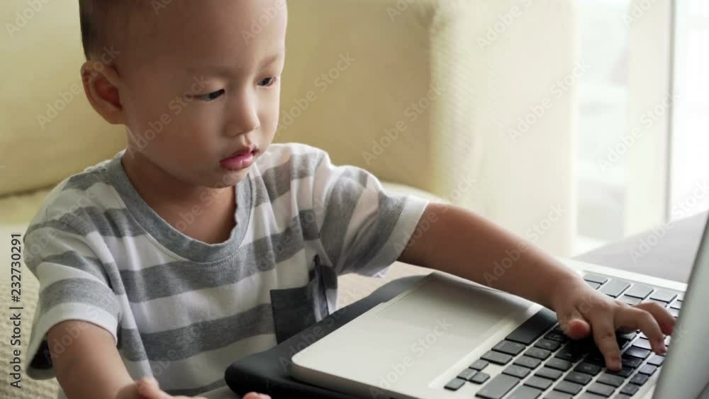 Child playing with laptop computer Child playing with laptop computer