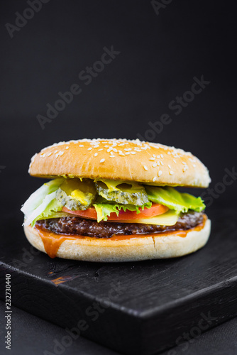 Homemade burger with grilled beef meatball, burger on a black backgroud, Craft beef burger, fresh tasty burger