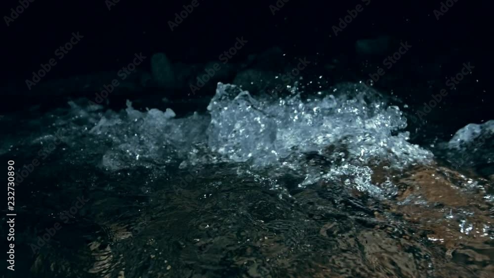 Slow motion of waves on dark water surface with play of flecks of bright light close up. Amazing dramatic natural background. Shooting with 180fps. Epic mystical and magic night view. Crystal clear Slow motion of waves on dark water surface with play of flecks of bright light close up. Amazing dramatic natural background. Shooting with 180fps. Epic mystical and magic night view. Crystal clear