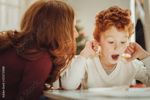 I knew it. Concentrated kid opening mouth and raising eyebrows while listening to his mother