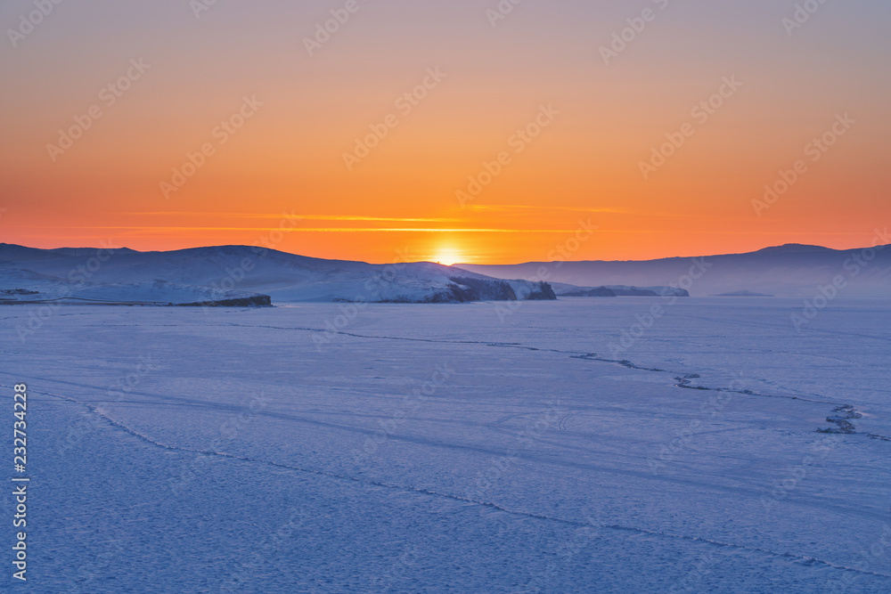 Panoramic frozen landscape in winter sunset at frozen lake Baikal in Siberia, Russia