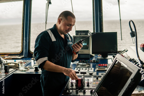 Obraz na płótnie Marine navigational officer is changing speed ship or vessel during navigation watch