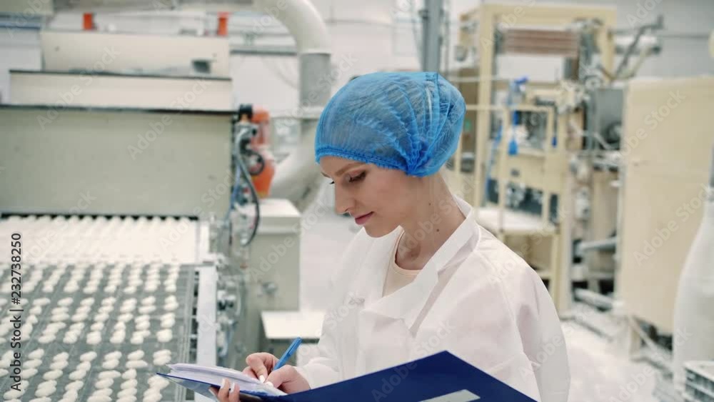 Candy factory. Controller checking conveyor with candies. Candy factory. Controller checking conveyor with candies.