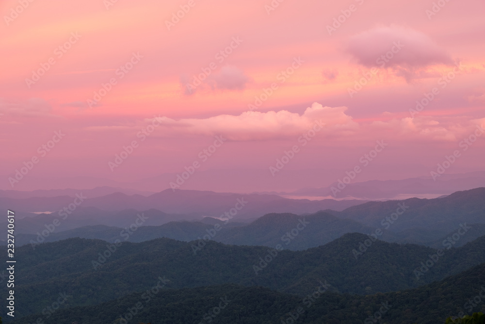 red color of sun and mountains layers during sunrise at Mea Kumpong, Thailand