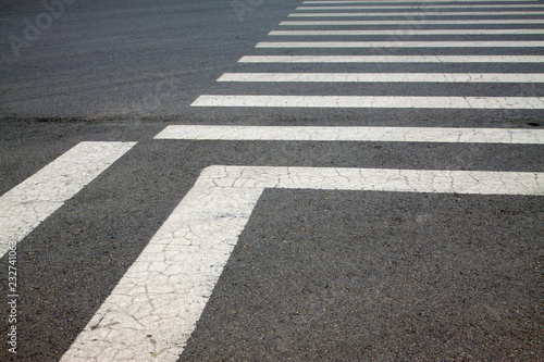 zebra crossing on asphalt pavement, closeup photo