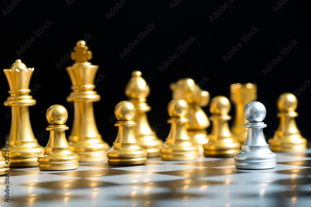 Silver pawn chess piece face with another gold team (Concept for company strategy, business decision and encounter the problem)