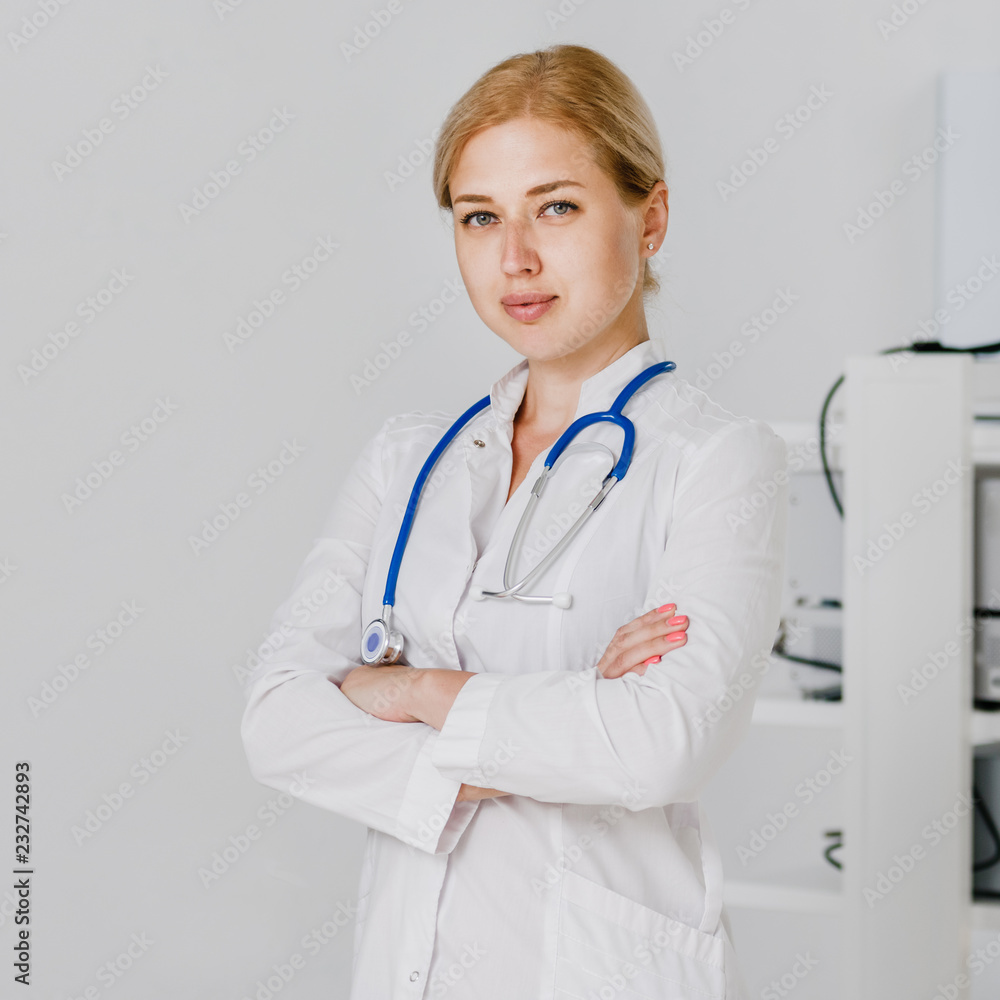 Young qualified doctor posing near ultrasound scanner machine Young qualified doctor posing near ultrasound scanner machine