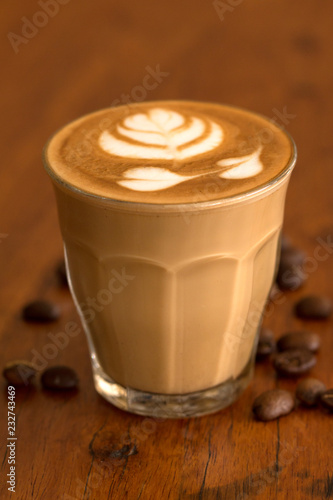 Fototapeta Naklejka Na Ścianę i Meble -  Coffee piccolo latte on wooden desk in coffe's shop