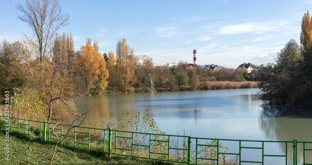 Autumn in city park, river,sky.