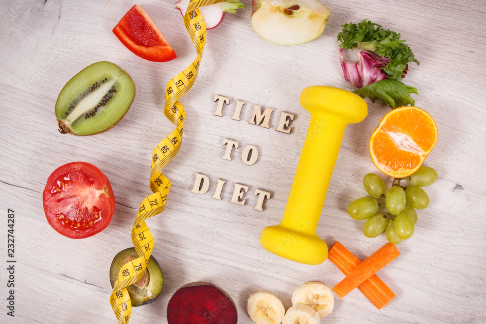 Fuits and vegetables, dumbbell for fitness and tape measure, concept of healthy lifestyles, nutrition and slimming Fuits and vegetables, dumbbell for fitness and tape measure, concept of healthy lifestyles, nutrition and slimming