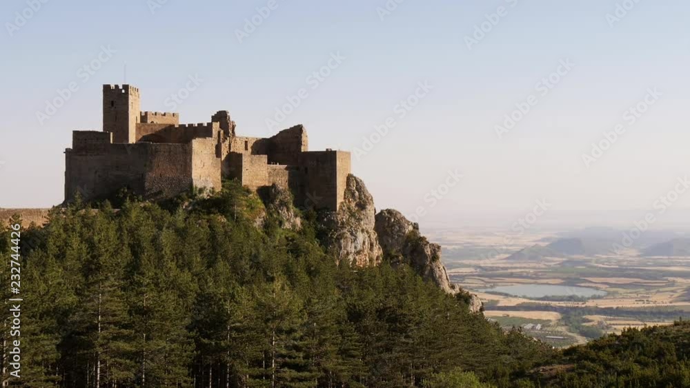 Castillo de Loarre / Castle of Loarre in Huesca, Aragon, Spain – wide wide shot withvalley and lake in background Castillo de Loarre / Castle of Loarre in Huesca, Aragon, Spain – wide wide shot withvalley and lake in background
