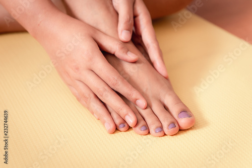 Close up of woman taking care of her feet, Healthcare concept
