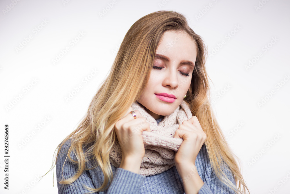 Winter portrait of young beautiful blonde woman wearing knitted snood. Christmas, cozy, fashion concept. Winter portrait of young beautiful blonde woman wearing knitted snood. Christmas, cozy, fashion concept.