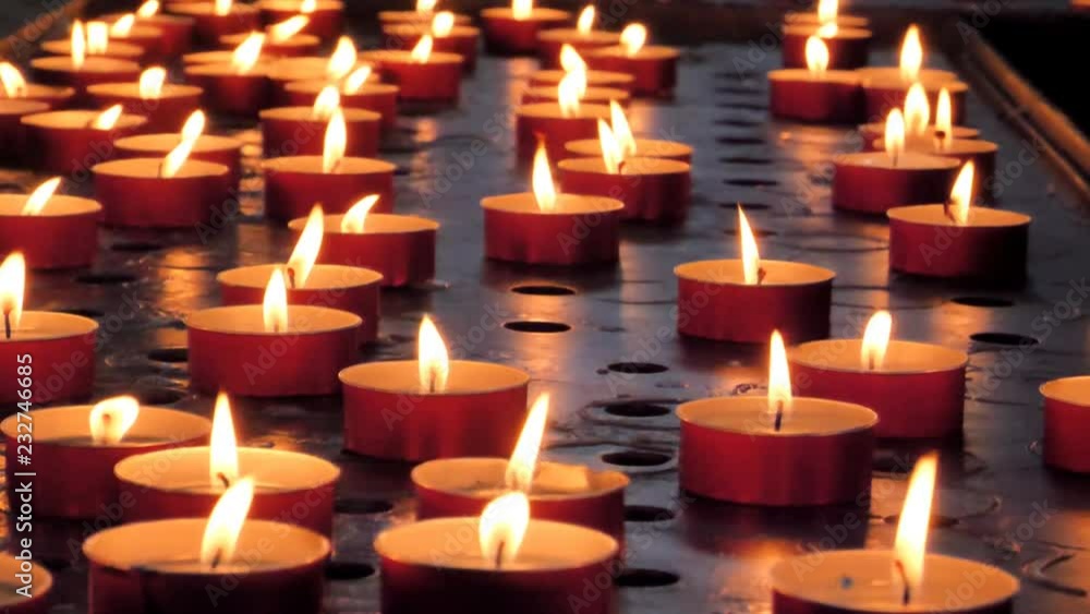 Many candles burn in dark. Closeup view Many candles burn in dark. Closeup view