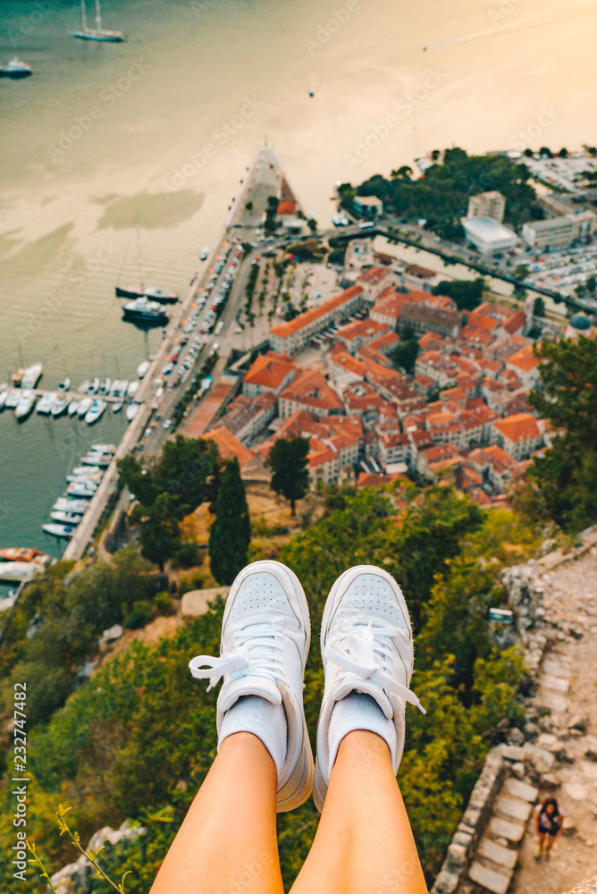 legs at hill with beautiful view of kotor city on background