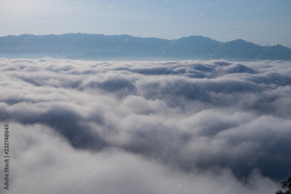 View of Fog covered the mountain in Aiyoeweng District, Southern Thailand, with trees.