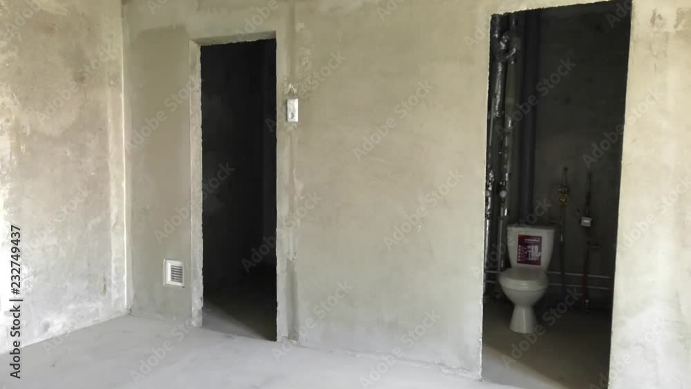 Unfinished, empty apartment without floor, with white walls. Developers are building more and more apartments. Real-estate business has good forecast. Unfinished, empty apartment without floor, with white walls. Developers are building more and more apartments. Real-estate business has good forecast.