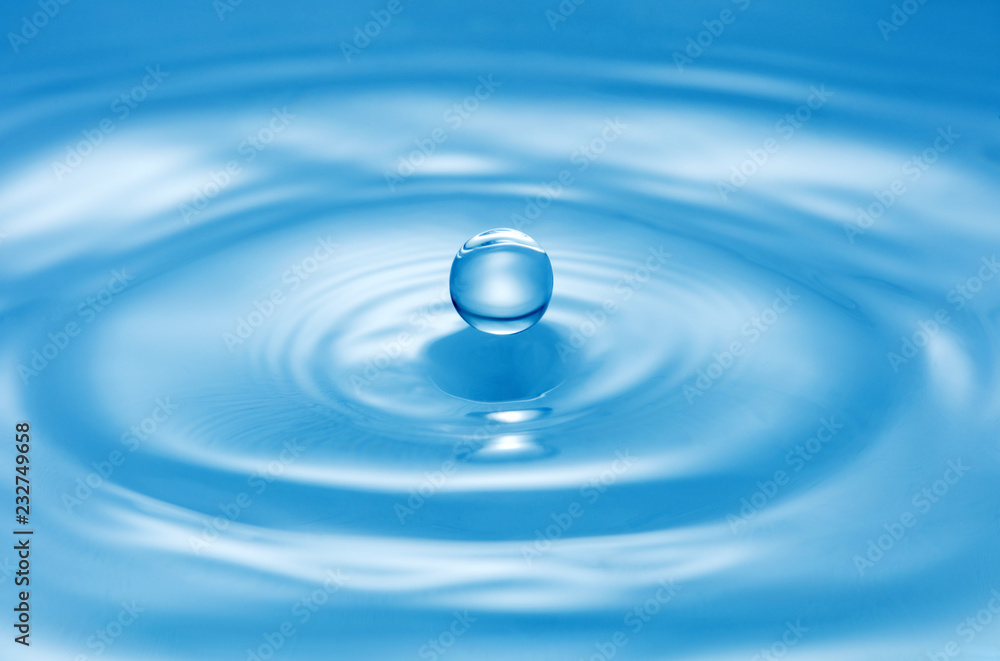 drop of water on blue water surface drop of water on blue water surface