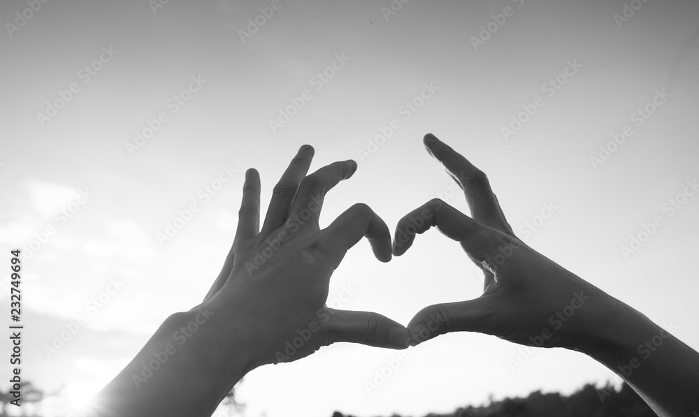 Hands in heart form love, silhouette hand make heart form with sun set Hands in heart form love, silhouette hand make heart form with sun set