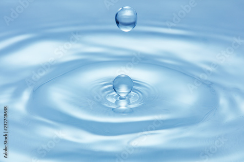 blue water surface with splash of droplet