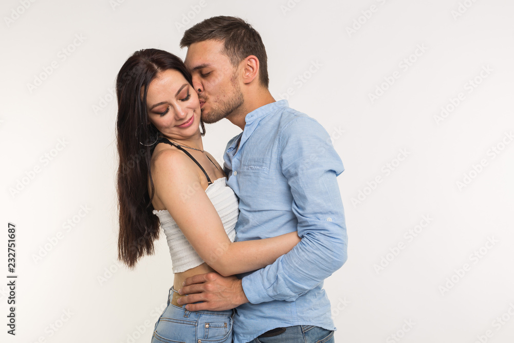 Handsome man hugging his girlfriend on white background Handsome man hugging his girlfriend on white background
