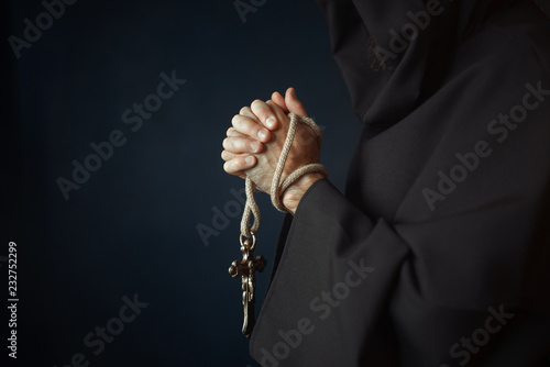 Fototapeta Medieval friar praying with wooden cross in hands