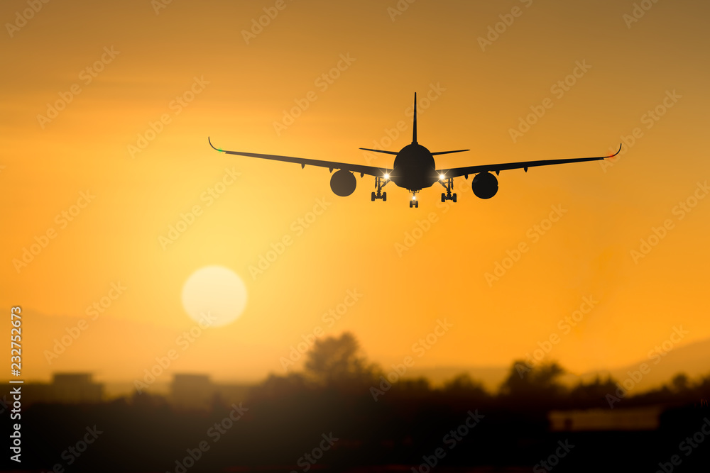 Silhouette airplane takeoff at sunset