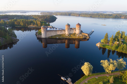 View of the Olavinlinna fortress in the Kuusalmi strait on a July morning (shooting from a quadcopter). Savonlinna, Finland photo