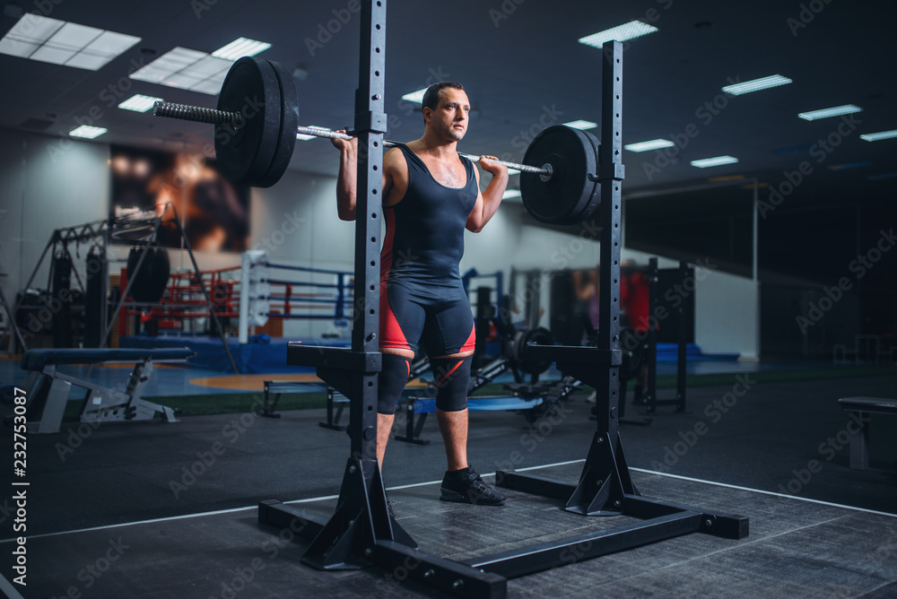 Athlete prepares to make squats with barbell Athlete prepares to make squats with barbell