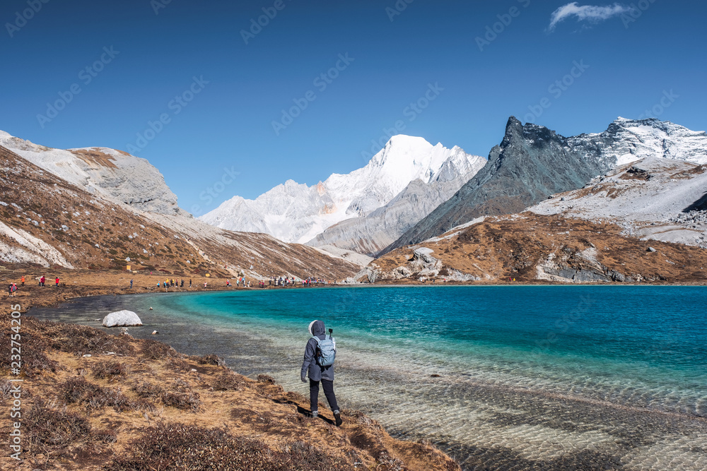 Young women trekking on top of Milk Lake in peak valley
