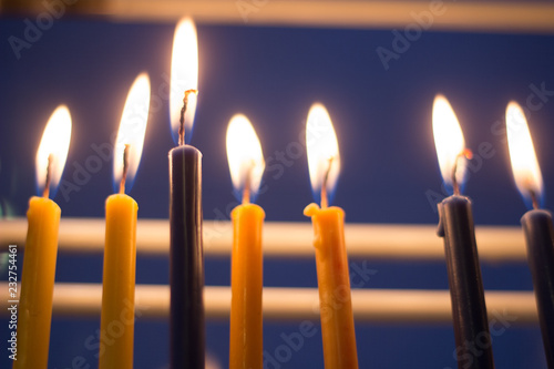candle hanuka menora by window for jewish holiday