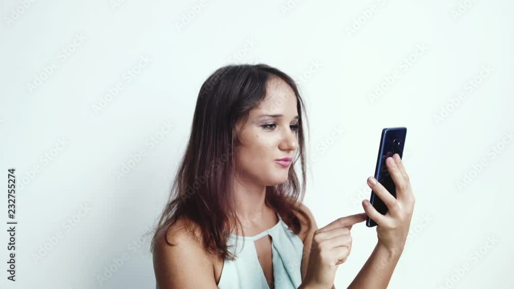 Businesswoman uses mobile phone press by media or social networks on a white background. close up. 3840x2160 Businesswoman uses mobile phone press by media or social networks on a white background. close up. 3840x2160