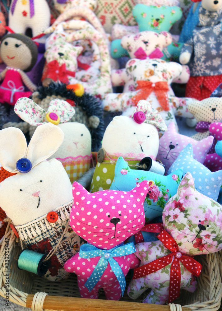 Colorful textile toys sitting in basket, fair for tourists, on sale